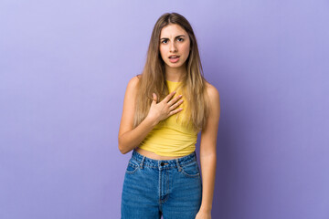 Young woman over isolated purple background pointing to oneself