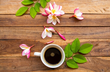 hot coffee espresso with colorful flowers frangipani in envelope arrangement flat lay postcard style on background wooden