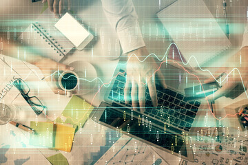 Double exposure of man and woman working together and forex graph hologram drawing. Financial analysis concept. Computer background. Top View.