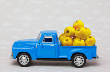 Toy Truck delivering  a bunch of yellow apples