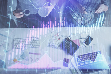 Double exposure of man and woman working together and financial chart hologram drawing. market analysis concept. Computer background. Top View.