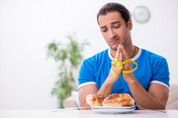 Young hungry man in dieting concept