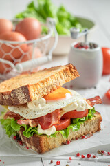 Crunchy sandwich with bacon, egg and mayonnaise. British breakfast.