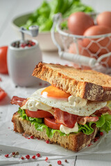 Homemade toasted bread with bacon, egg and mayonnaise. British breakfast.