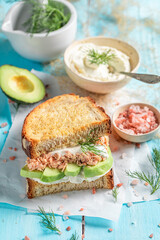 Homemade sandwich with salmon and avocado for fresh lunch.