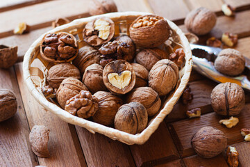 chopped nuts in a heart-shaped basket. nearby lies the iron nutcracker.