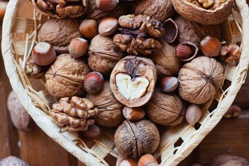 chopped nuts in a heart-shaped basket. nearby lies the iron nutcracker.