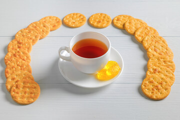 High resolution photo: Tea cup with crackers and some marmelade