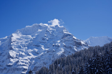 Fototapeta na wymiar Panorama of Bernese Alps with Mountain Peak Jungfrau (virgin), seen from Mürren, Switzerland.