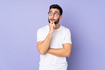 Caucasian handsome man over isolated background having doubts and thinking