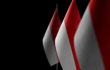 Small national flags of the Indonesia on a black background