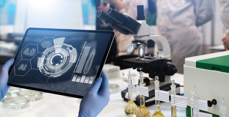 A tablet with infographics in the hands of a scientist. Grain analysis in the laboratory. Technologies.