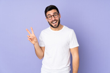 Caucasian handsome man over isolated background smiling and showing victory sign