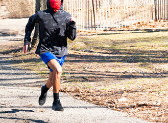 Runner wearing face mask for protection running in a park