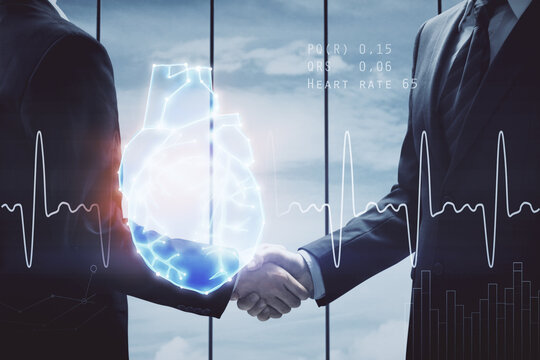 Double exposure of heart hologram and handshake of two men. Medical concept