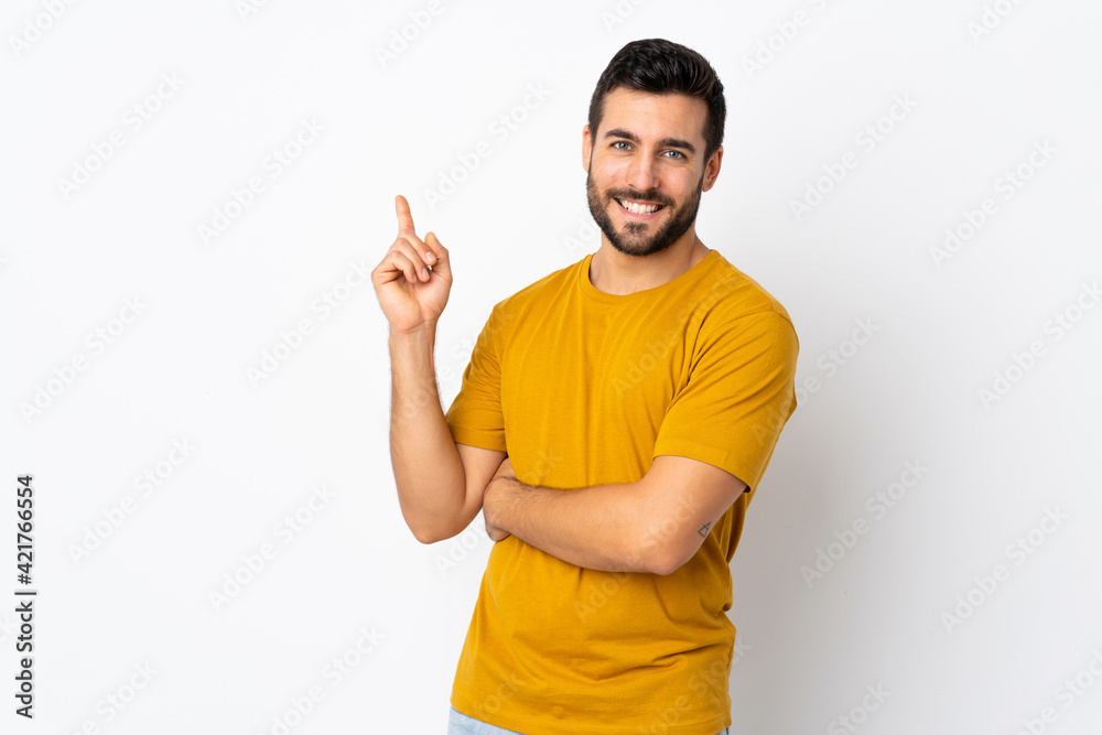 Canvas Prints Young handsome man with beard isolated on white background happy and pointing up