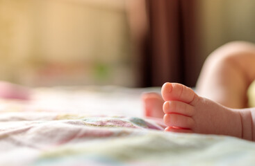 Obraz na płótnie Canvas baby leg on blur background close up