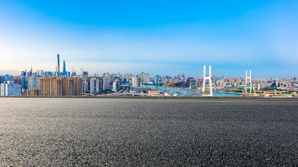 Asphalt highway and city skyline with bridge at dusk in Shanghai,China.