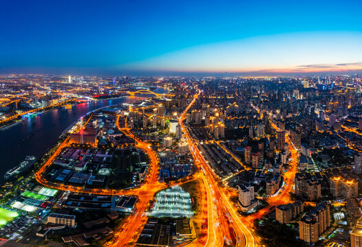 Aerial view of modern city skyline and buildings at night in Shanghai. © ABCDstock