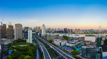 Aerial view of modern city skyline and buildings at dusk in Shanghai.