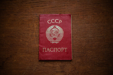A civil passport of the old USSR model on a wooden table.
