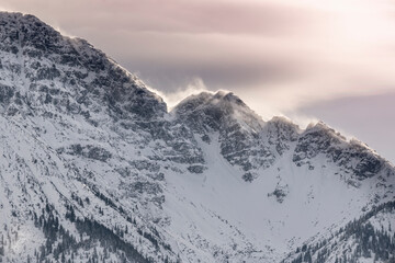 ridge of the rocky mountain thaneller in reutte in tyrol in winter with snow drifts at sunset