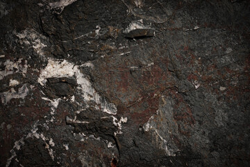 Rough cave stone wall surface with natural cracks used for background.