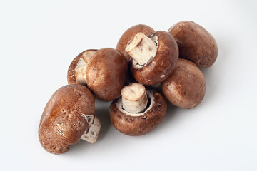 Fresh mushrooms on white. Brown champignons. A bunch of mushrooms.