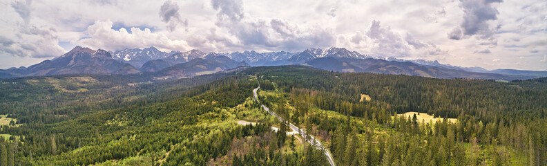 Spring rainy weather mountain panorama. Green forest hills. Road from Poland to Slovakia