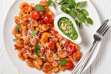 Potato gnocchi with tomatoes and pesto, top view