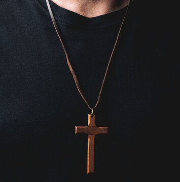 Man wearing wooden Christian cross pendant