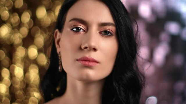 Closeup face of luxury woman with perfect skin posing at bright bokeh. Shot with RED camera in 4K