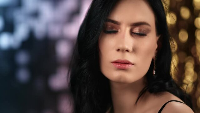 Seductive Asian lady with bright makeup making silence gesture. Close up shot on 4k RED camera