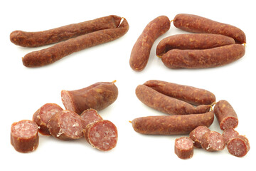 Traditional Dutch smoked and dried  sausages and some cut pieces on a white background