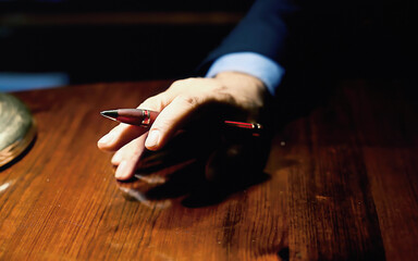 The hand of a nervous boss beating on a wooden table with anger. Closeup shot.
