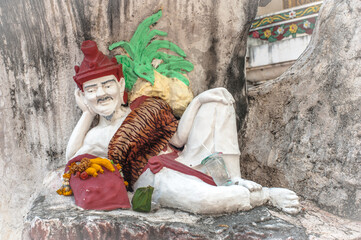 The lay down Anchoret sculpture at Wat Amarinthraram Worawihan temple in Bangkok Thailand 