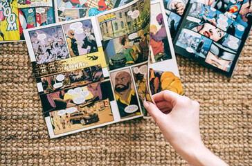 Naklejka premium Woman reads manga comic book on the carpet at home. Rostov-on-Don, Russia. 18 March 2021