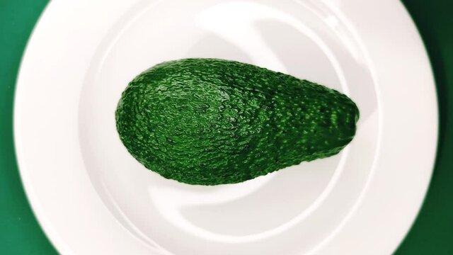 Avocado fruit on a plate. A source of polyunsaturated fatty acids.