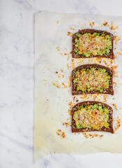 Delicious appetizer of rye bread baked with zucchini, parmesan cheese and almonds. Bruschetta. Bread toast. Healthy breakfast for gourmets. Selective focus, top view, copy space