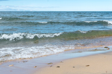 Seascape of the Lake Baikal. Waves with froth coming to the shore. Lifestyle.