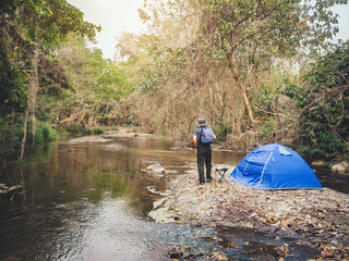 Summer camping near stream in tropical forest