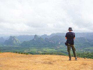 Fototapeta na wymiar Solo traveller enjoying beautiful nature of hills and during rainy season at Doi Tapang, Sawi District, Chumphon, Thailand.
