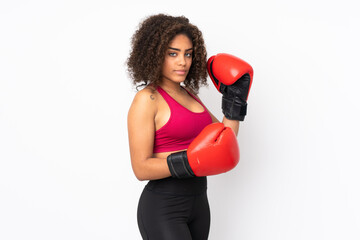 Young African American sport woman isolated on white background with boxing gloves