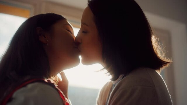 Happy Lesbian Couple Kissing at Home. Two Lovely Girls Spending Time Together, Enjoying Sunny Day. cinematic Slow Motion Shot of Authentic Tender Moments between Lovely Girlfriends 