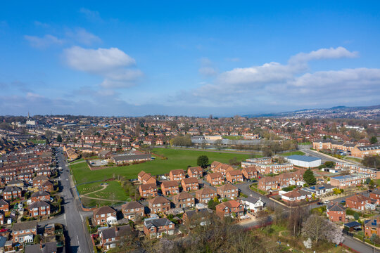 Aerial photo of the town of Kirkstall in Leeds West Yorkshire in the UK, showing a drone view of the village with rows of suburban houses and roads