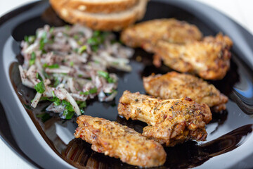 grilled chicken wings,  bread and onion salad