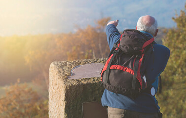 An Active Male Hiker or Explorer Looking at a Scenic Far View Pointing His Fingers to a Location or destination