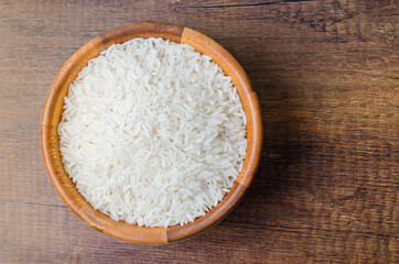 Organic Thai Jasmine rice grain in wooden bowl.