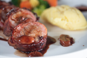Pork tenderloin wrapped with bacon. Delicious healthy food served for lunch in restaurant
