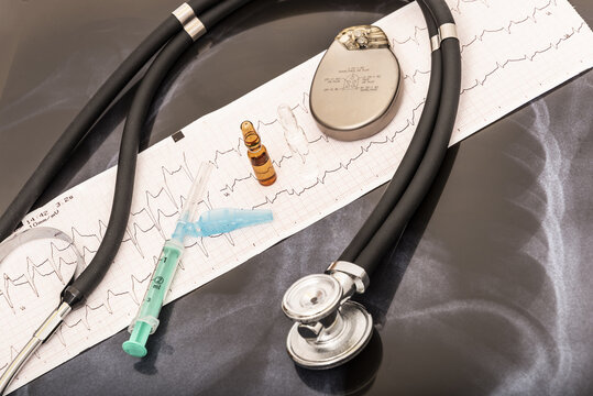 still life of a stethoscope with pacemaker battery and medical objects